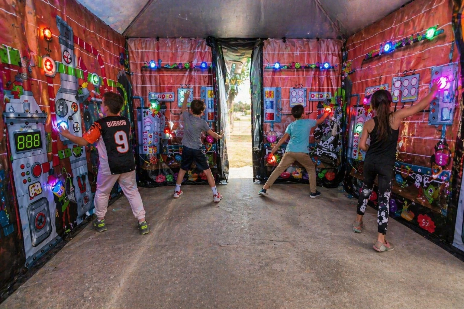 Kids using the interactive play system rental at a school event.