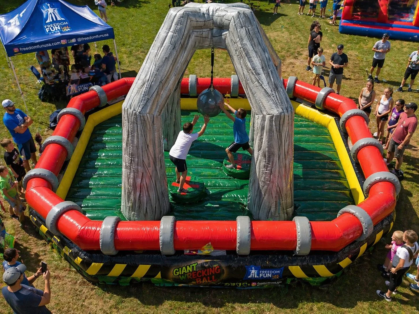 Kids playing on a giant wrecking ball inflatable rental.