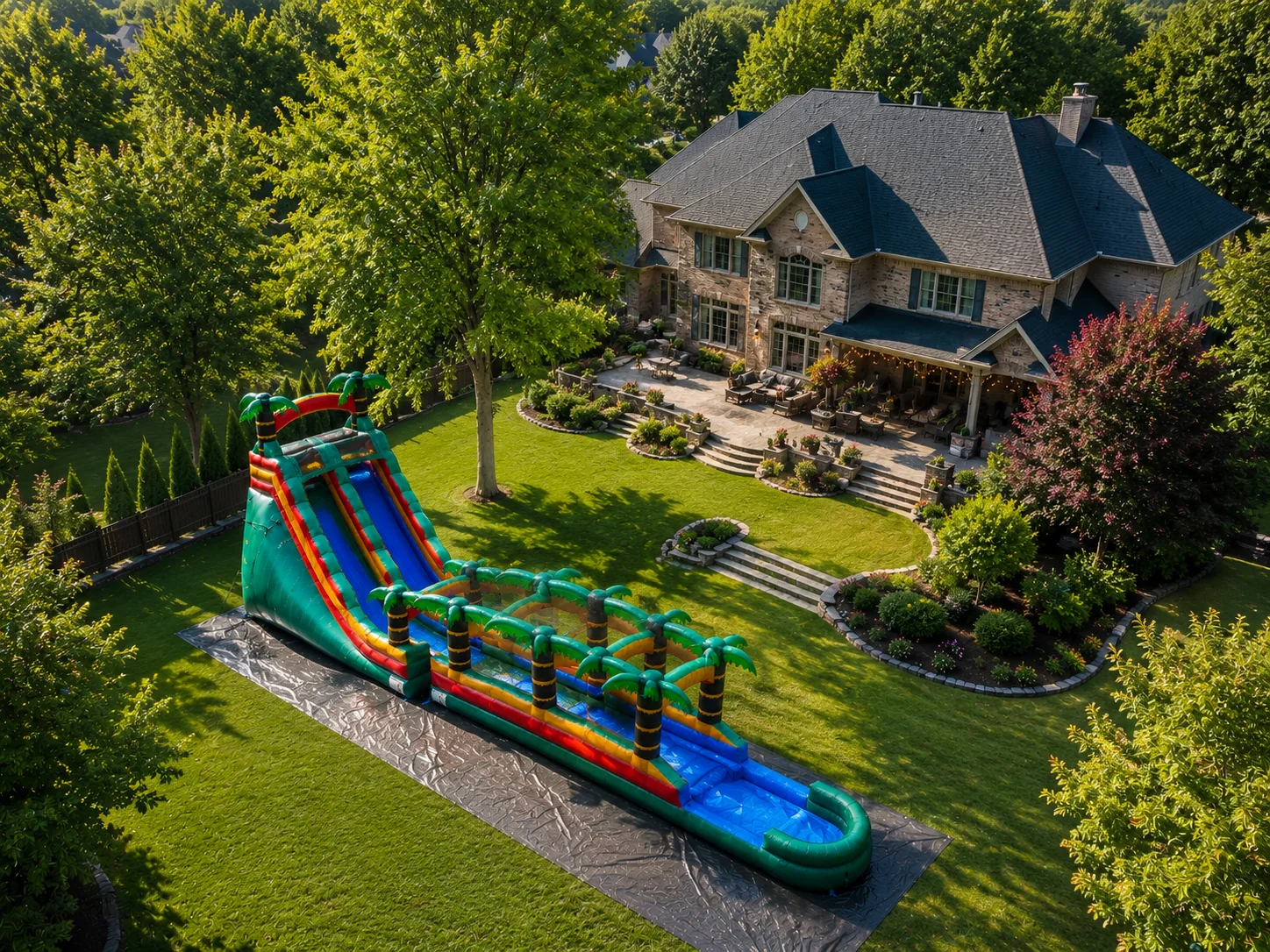 Aerial view of 18 ft Paradise Falls tropical waterslide rental in Winston-Salem NC backyard