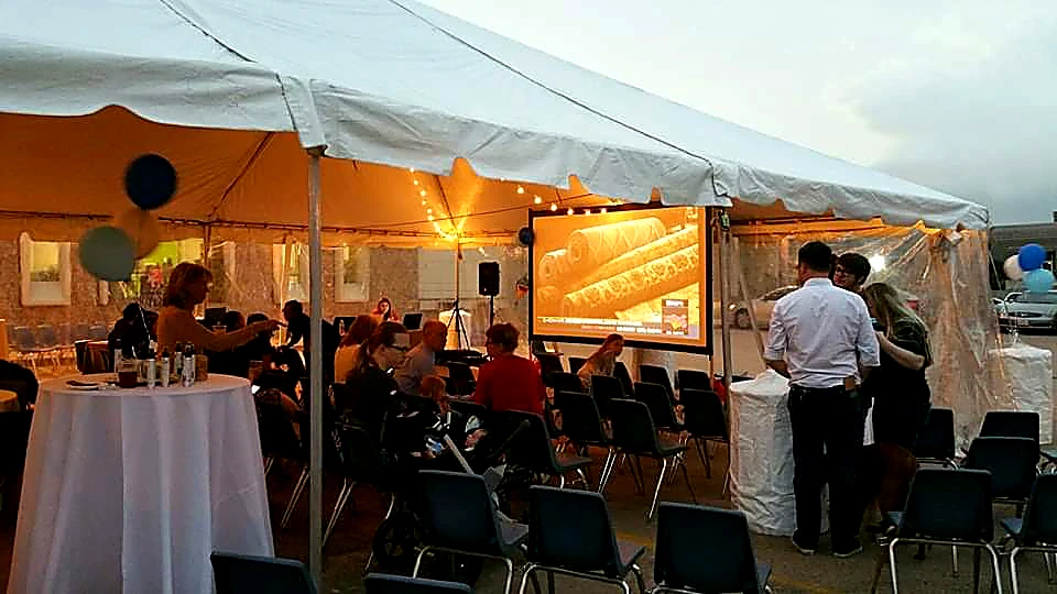 Inflatable projector screen rental at a community event.