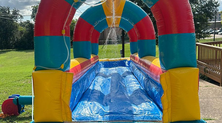 Kids enjoying our inflatable water slide rental.