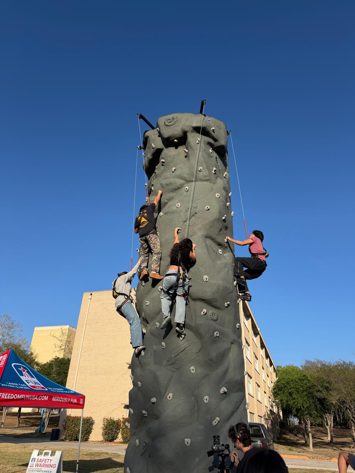 Rock climbing wall rental setup at an outdoor event.