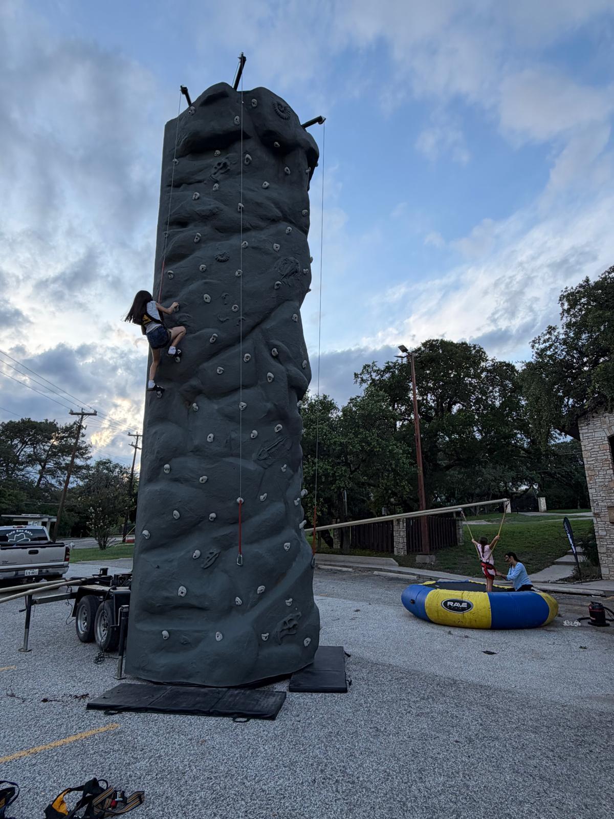 Rock climbing wall rental setup at an outdoor event.