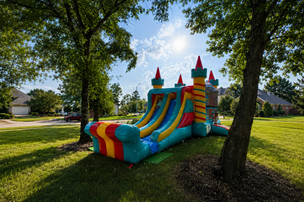 Freedom Extreme wet or dry combo bounce house and dual-lane slide set up outdoors in Houston.