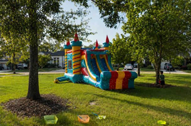 Freedom Extreme combo bounce house shown from the slide side at an outdoor Houston event.