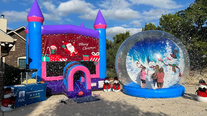 Inflatable snow globe rental at a holiday party.