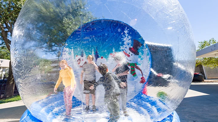 Human snow globe rental at a Christmas party.