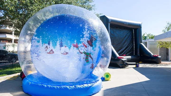 Walk-in inflatable snow globe rental for holiday events.