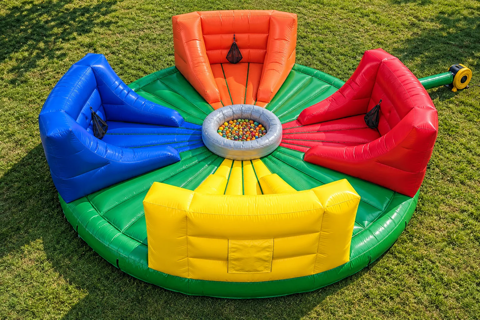 Aerial view of the four-player Hungry Hippo inflatable with colorful lanes and a central ball pit.