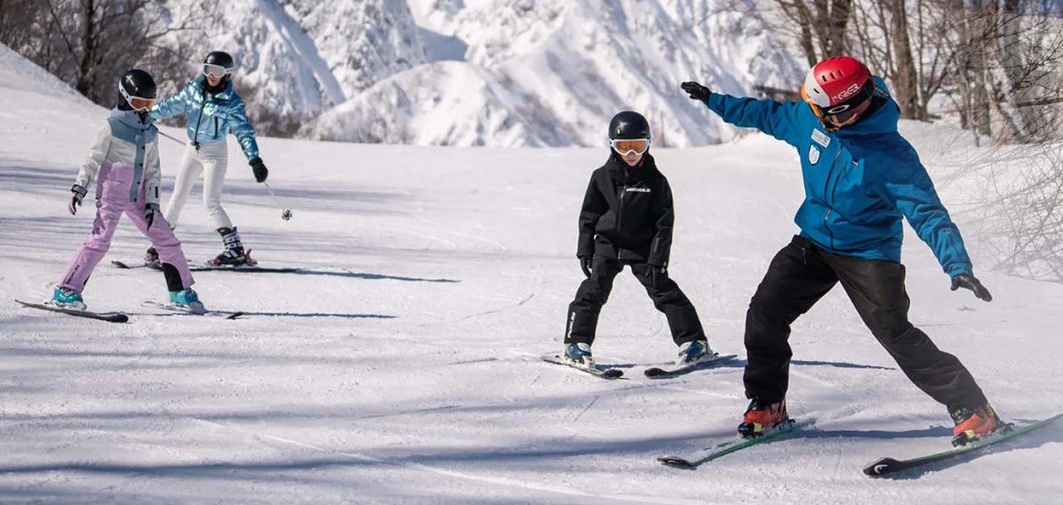 Ski instructors teaching young children