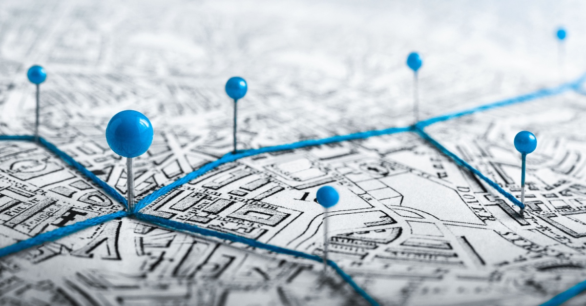 Street map with blue pins marking delivery stops, connected by a highlighted blue route.