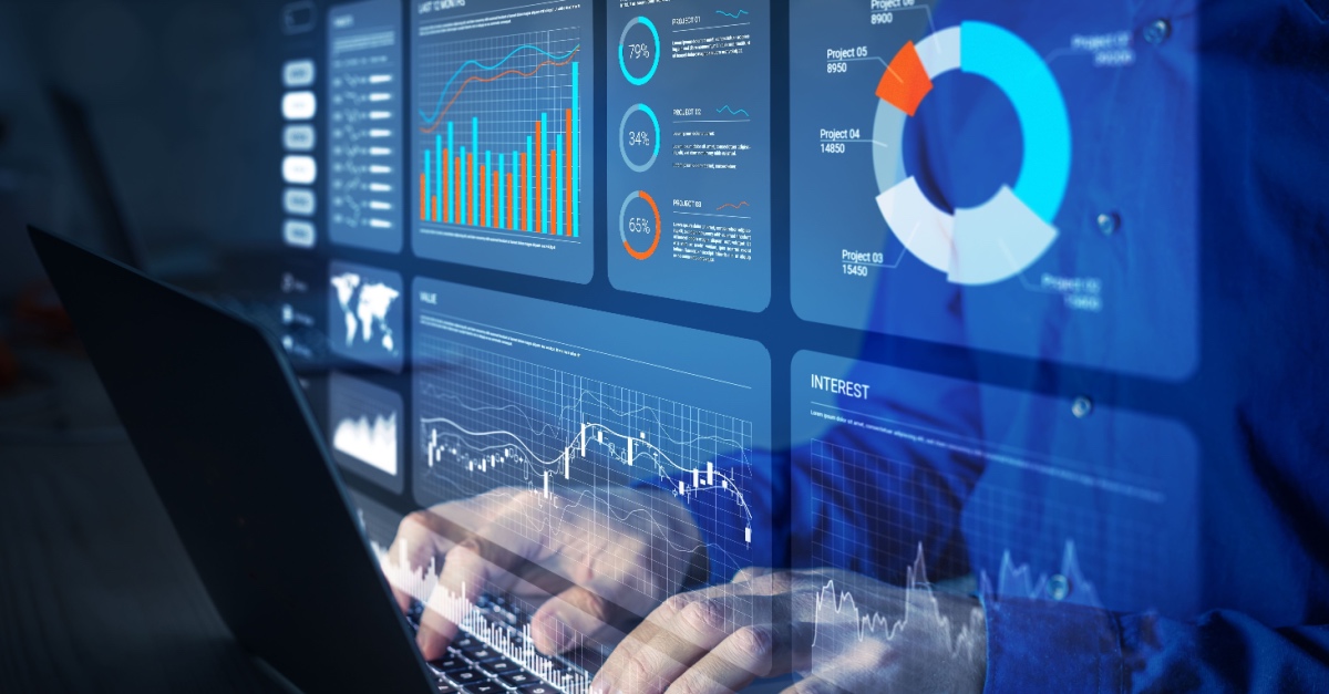 Person typing on a laptop behind an overlay of blue analytics dashboards, bar charts and a donut chart.