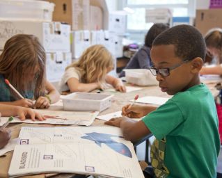 A couple of kids doing school work