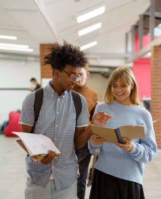 An image of two students walking the school hallway while talking.