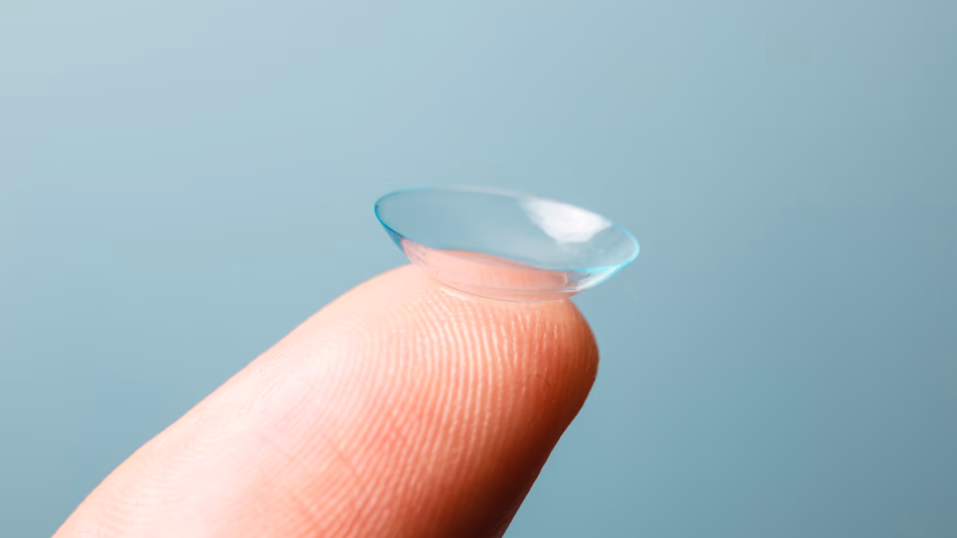 A single contact lens on a finger tip