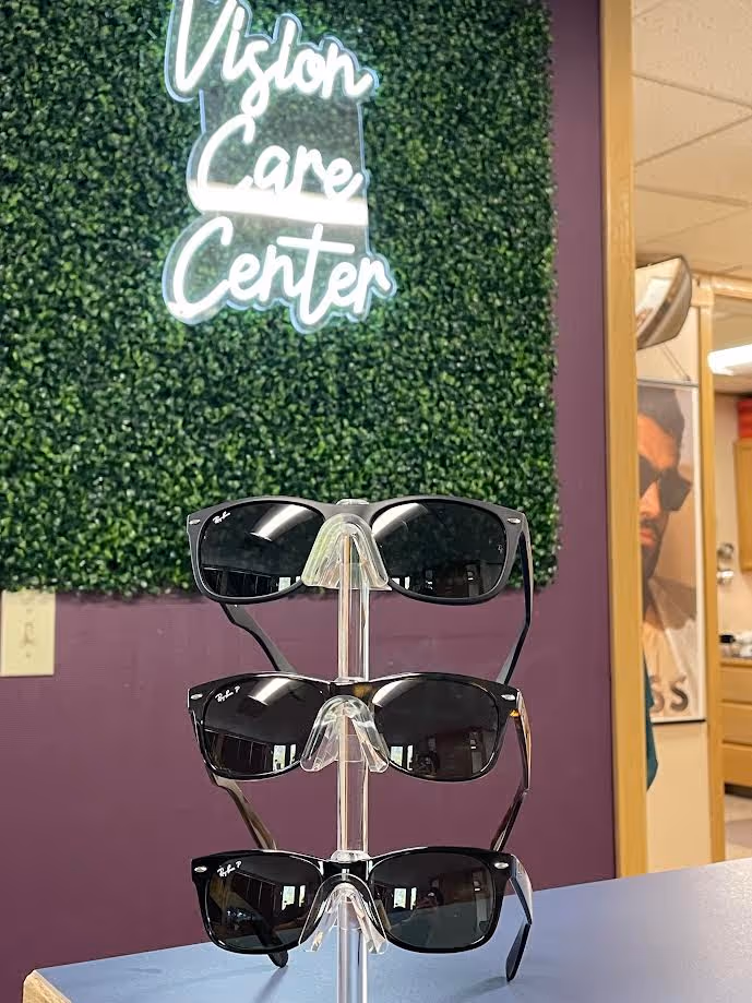 three pairs of Rayban sunglasses on a display stand