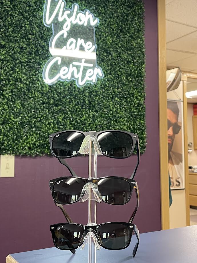 three pairs of Rayban sunglasses on a display stand