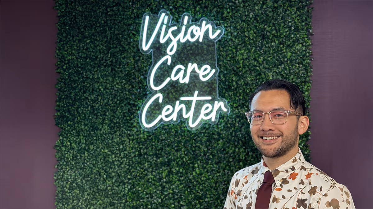 Dr. Jin portrait in front of Vision Care Center sign