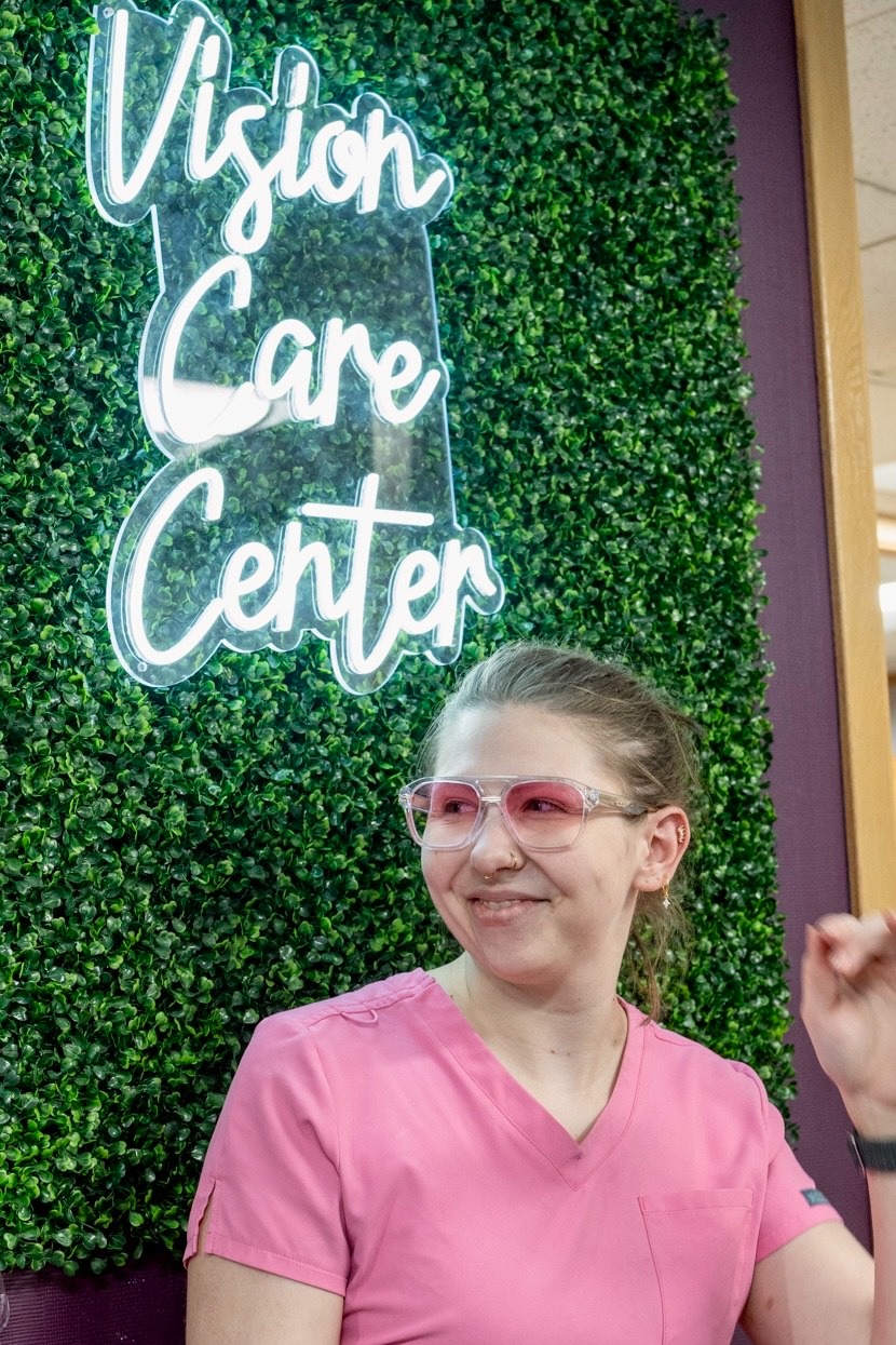 Portrait of optician, Erika wearing double bar Marc Jacob frames with pink gradient fashion tint