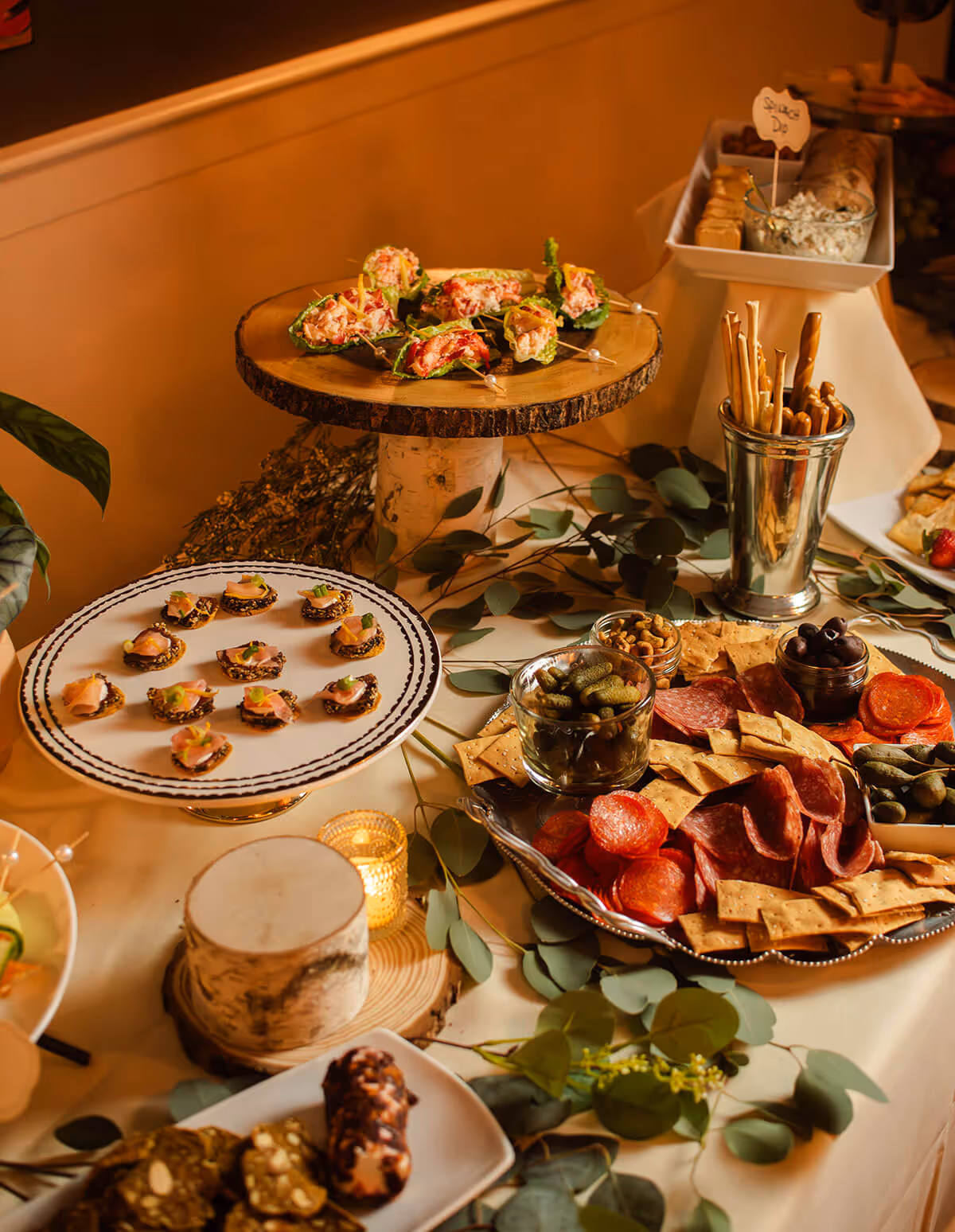 beautifully plated appetizer with greens, cookies, meat, and decorative flowers