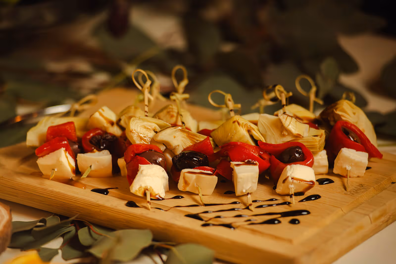 skewer with olives, cheese, vegetables and sauce