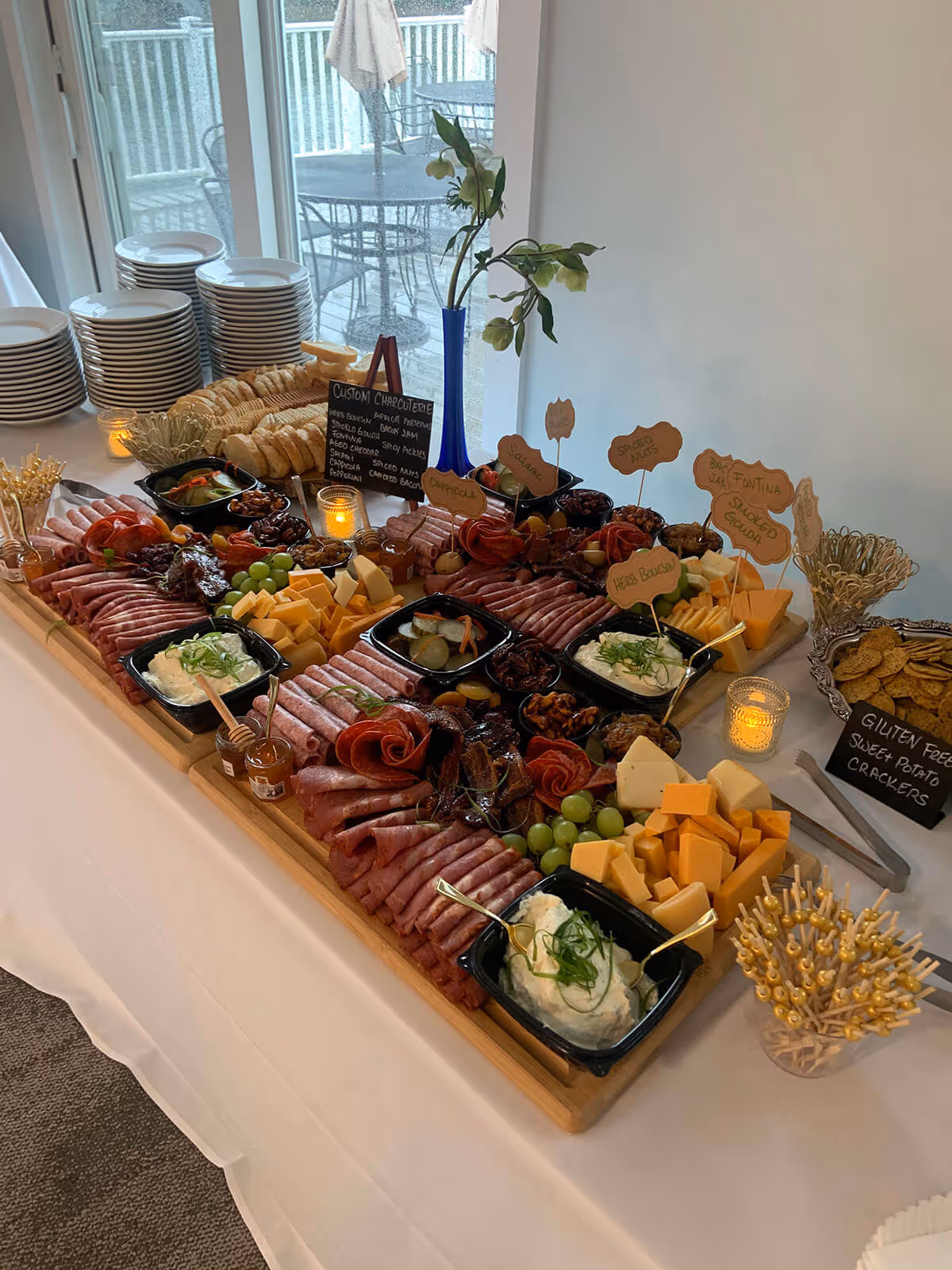 table with a variety of meat starters, cheeses, ham, sauces and bread - special occasions concept