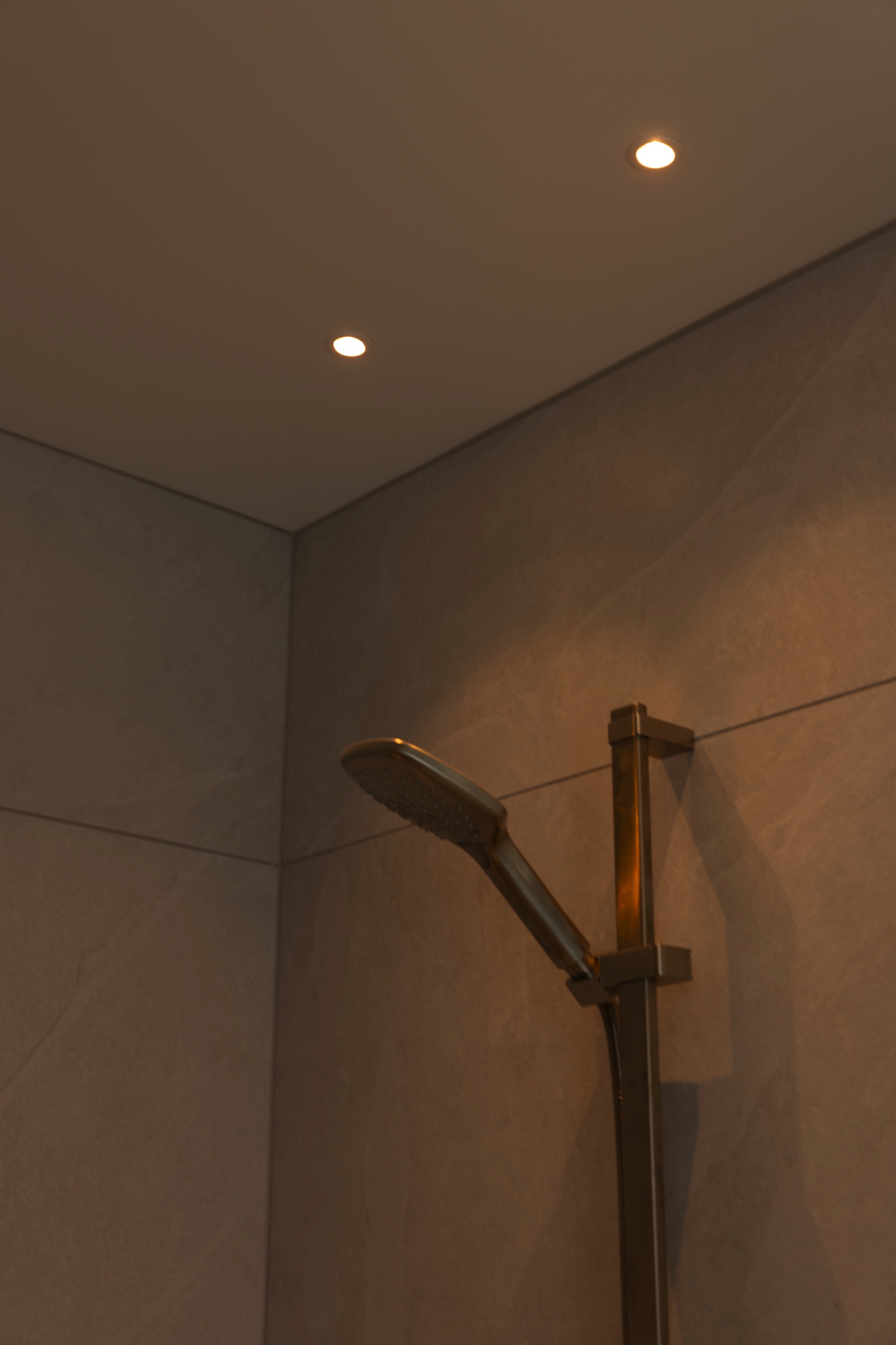 Shower cubicle with mini downlights installed to ceiling