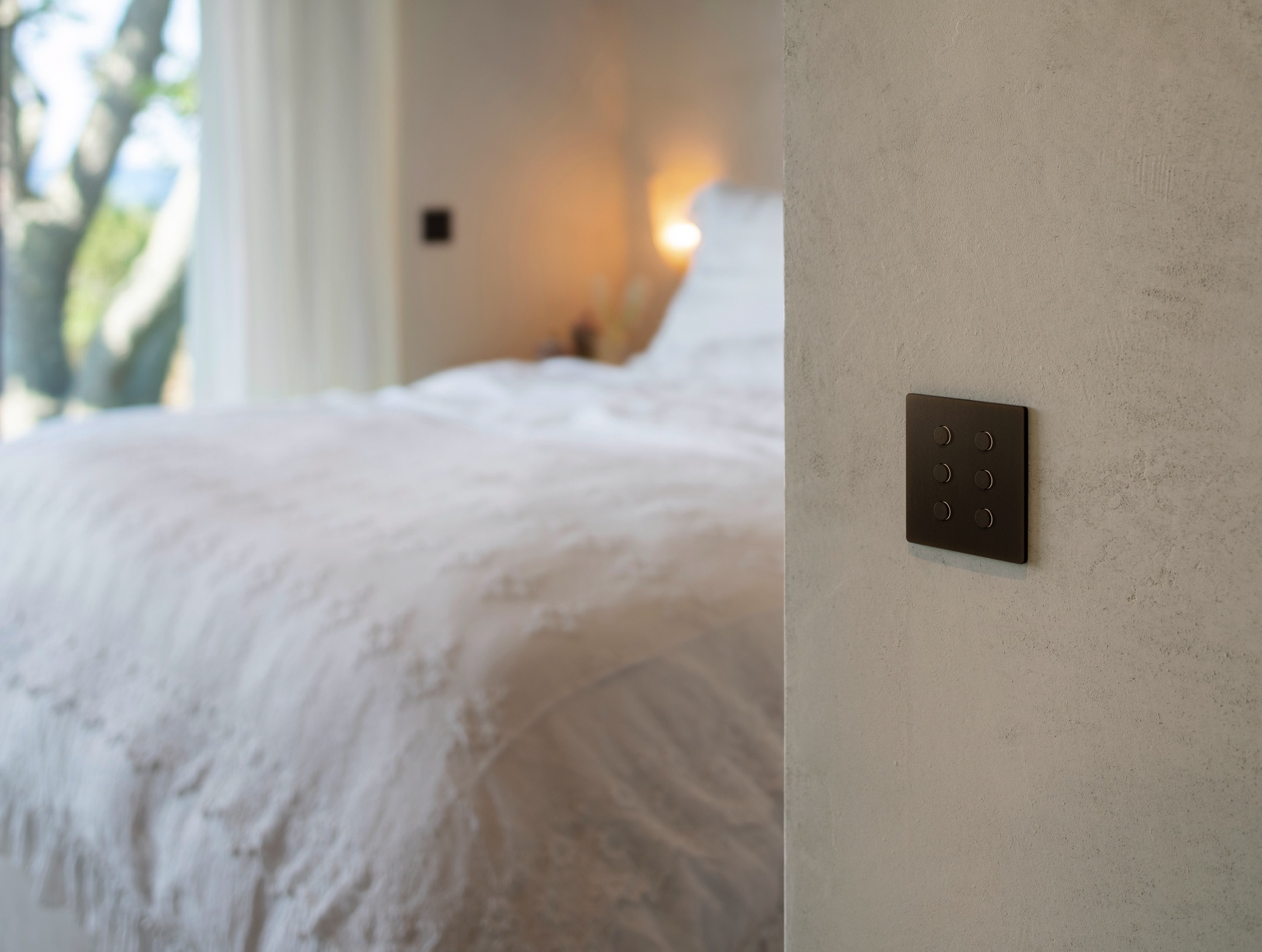 Lutron Alisse Keypad with Bronze finish installed in bedroom