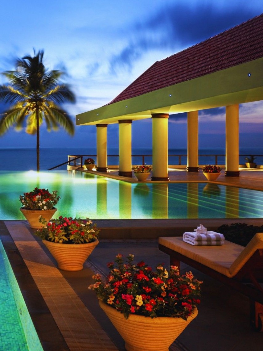 Luxury beach resort with pool and palm trees in India