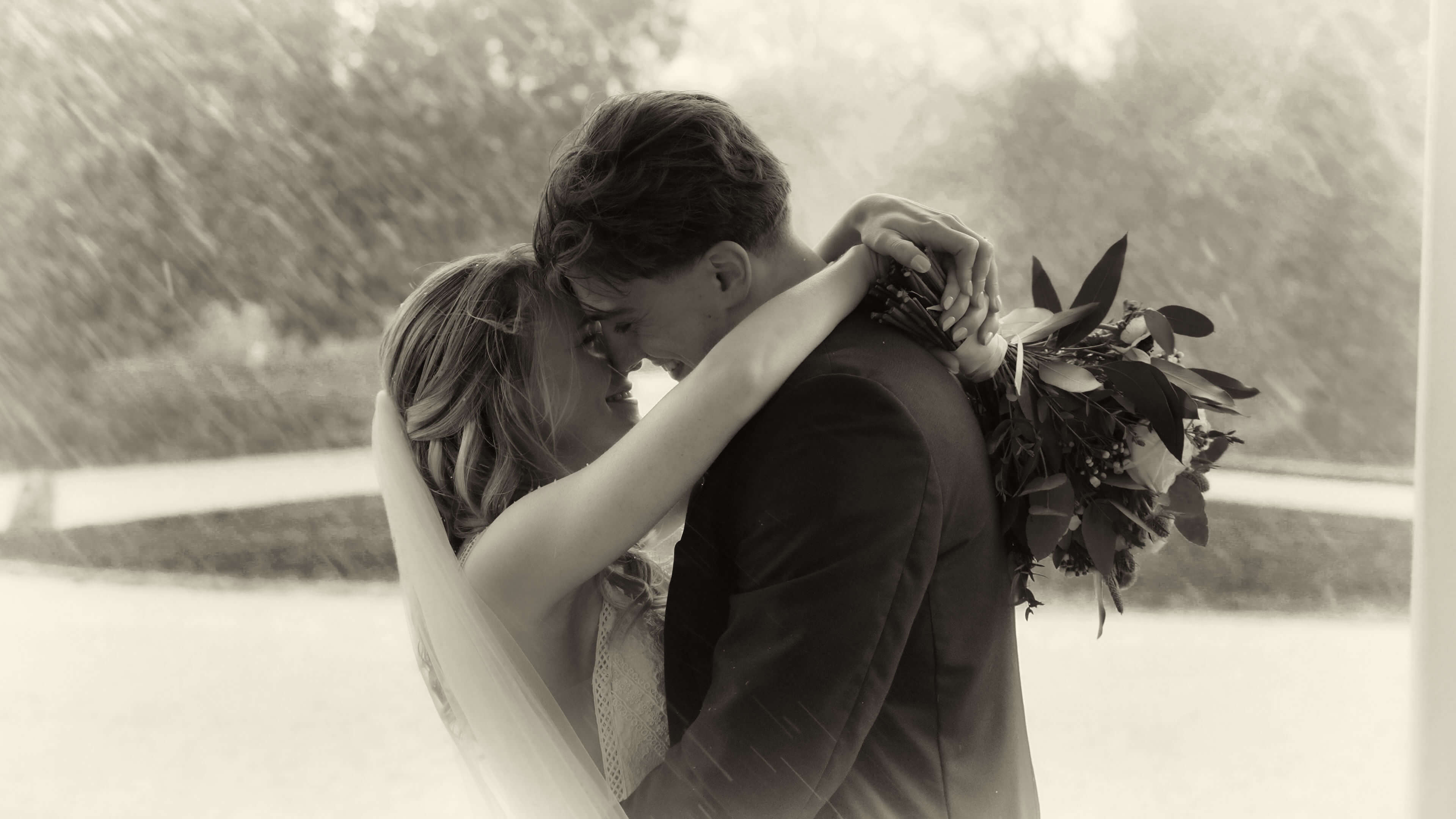 bride and groom in the rain