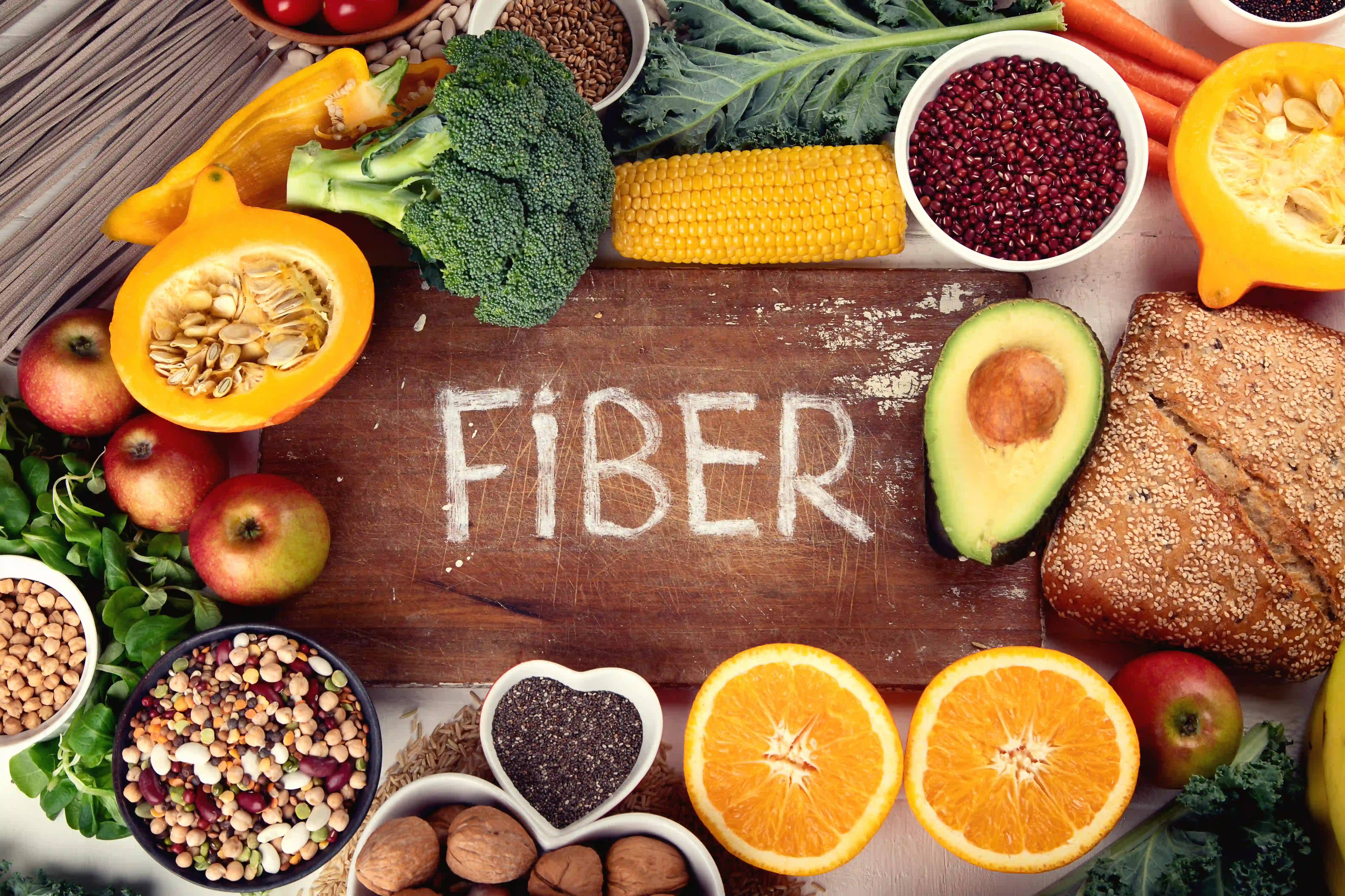 Cutting board with the word "Fiber" surrounded by high fiber foods
