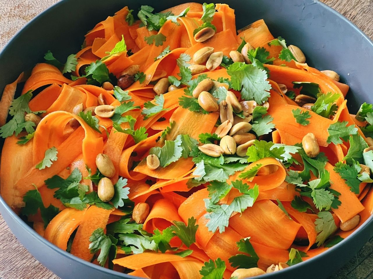 Large bowl of asian carrot slad with peantus and cilantro