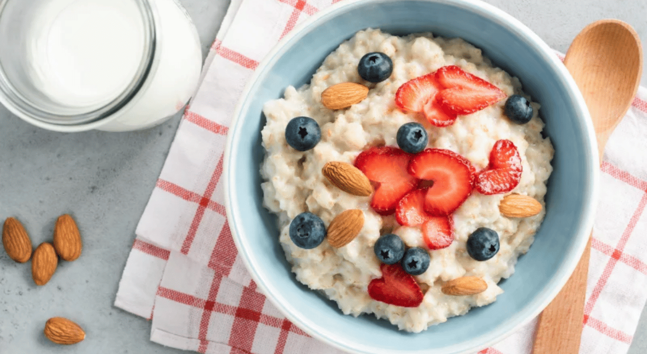 A bowl of coconut rice porridge topped with berries