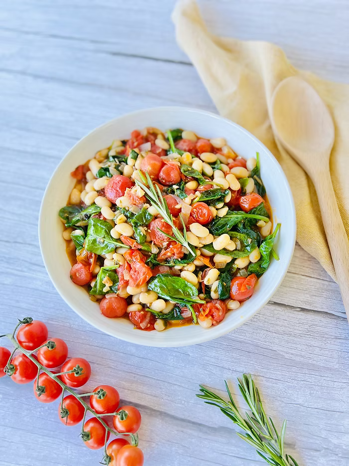 Garlic white bean stew with fresh herbs, wilted tomates and spinach