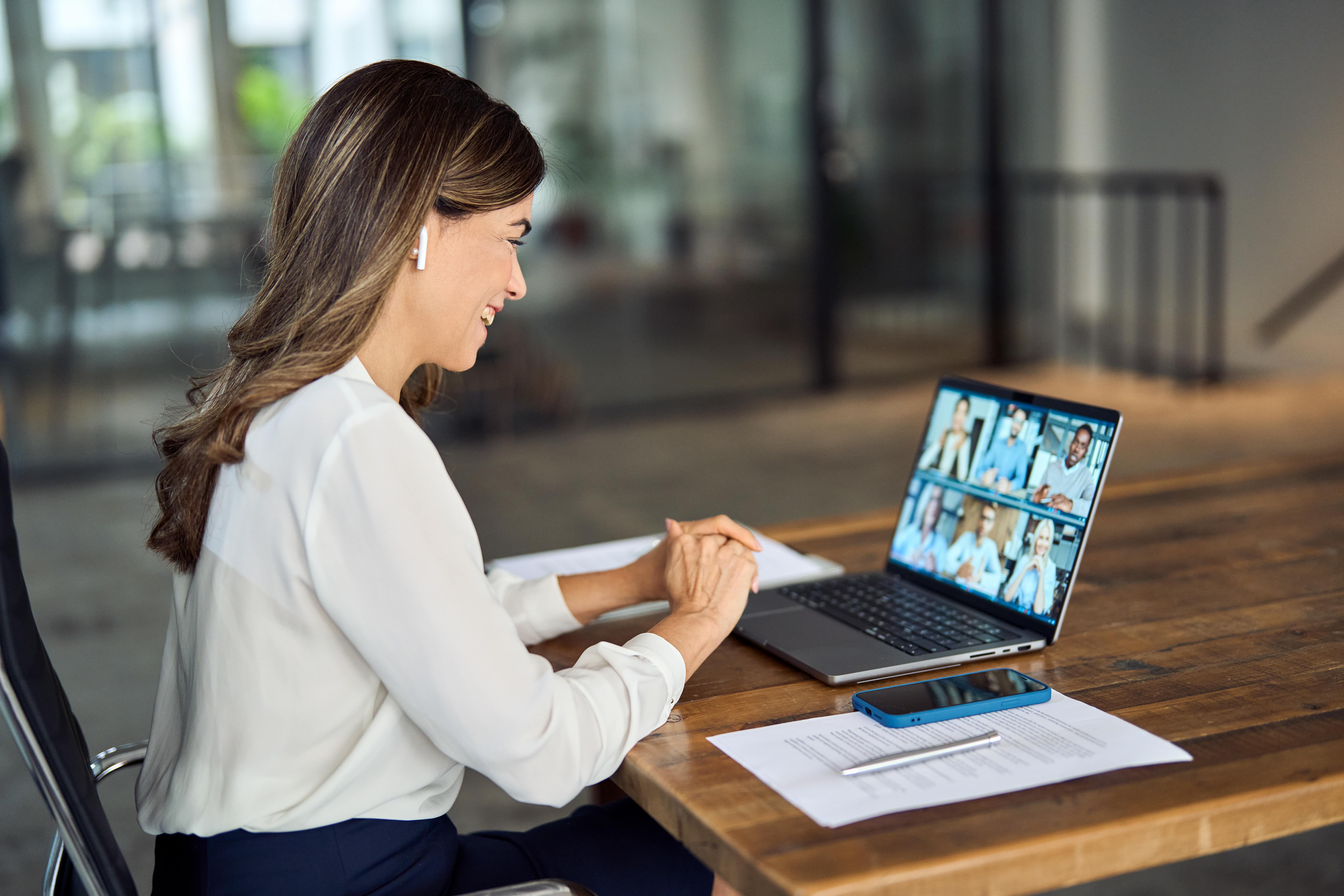 Woman on a Zoom call, consulting with clients.