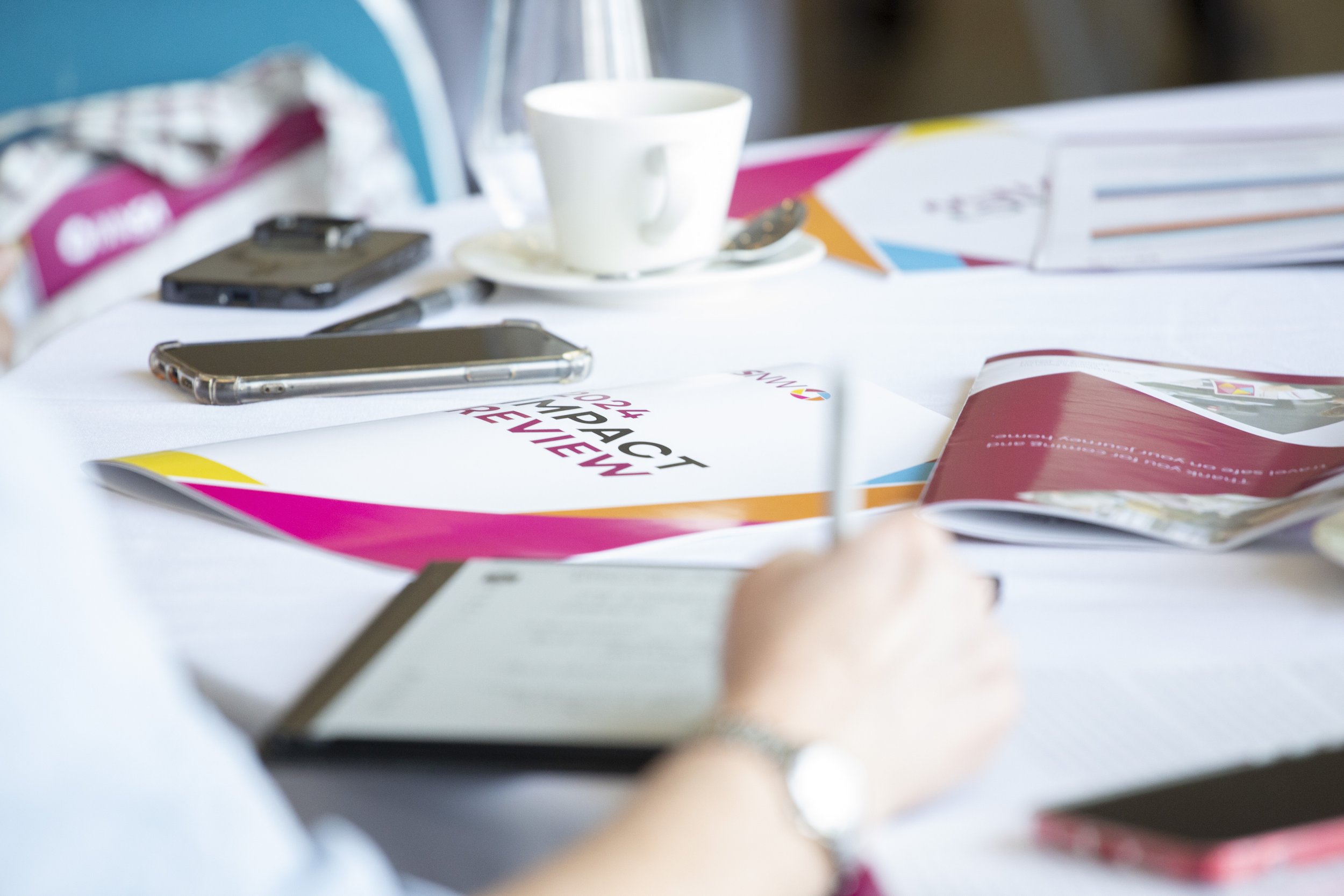 VNSW impact report is pictured on a table at a conference