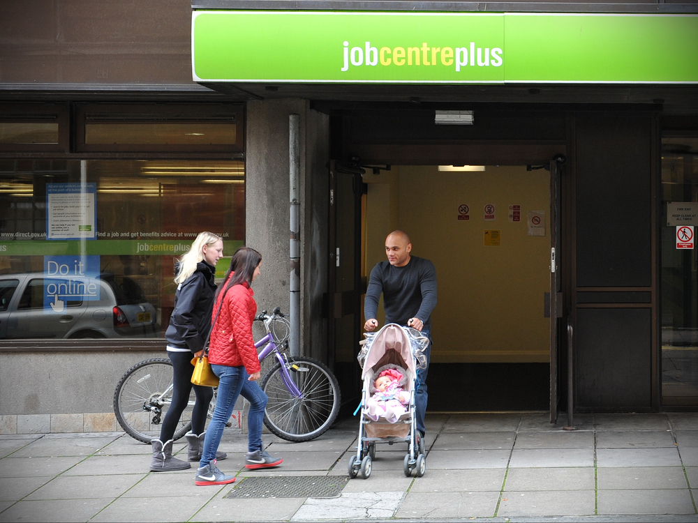 People visit a Jobcentre Plus on a city centre street.