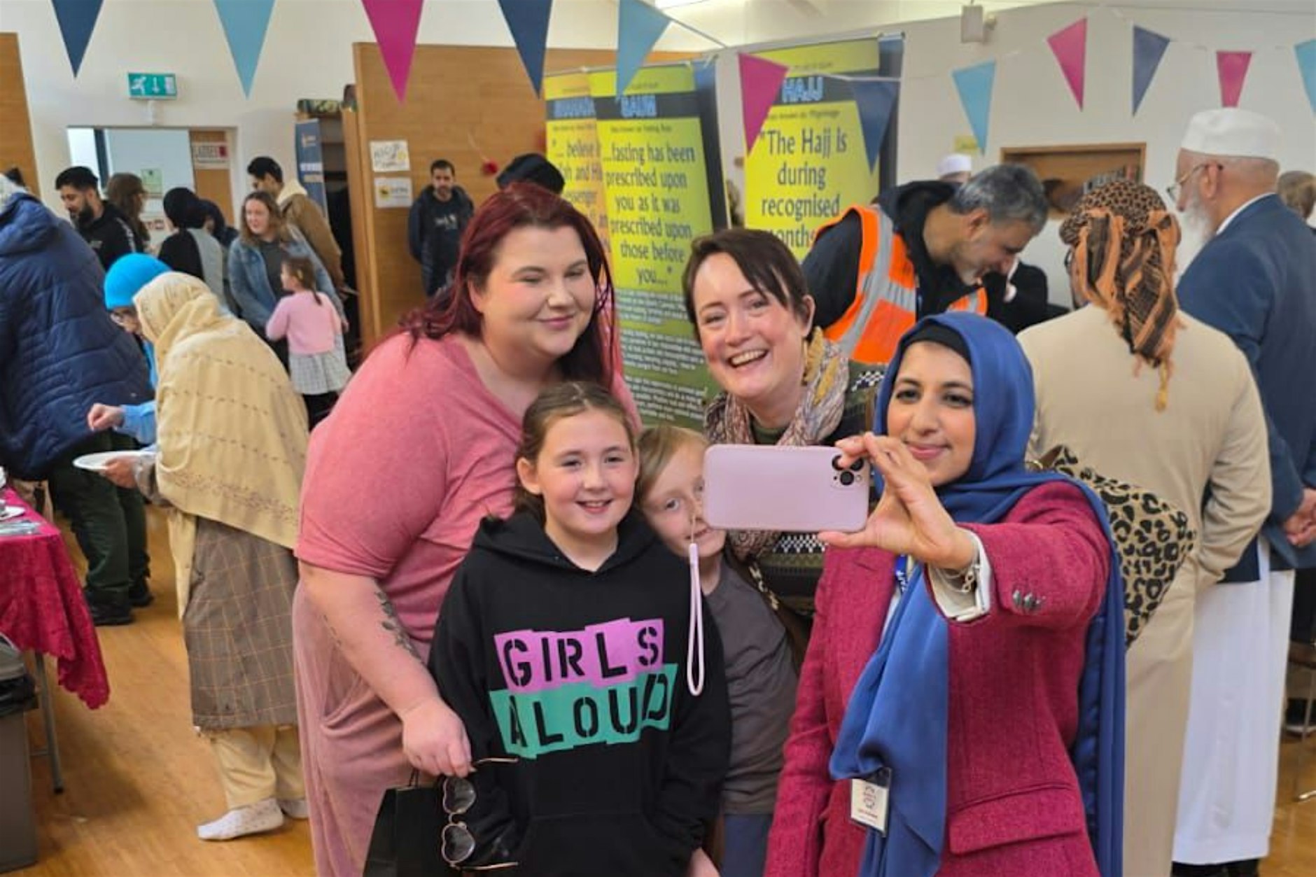 Women and children taking a photograph together