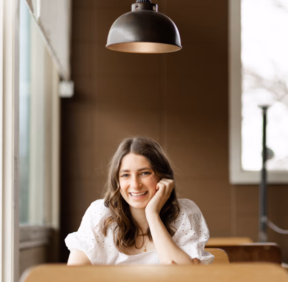 Lauren Smiling at Camera in Coffee Shop