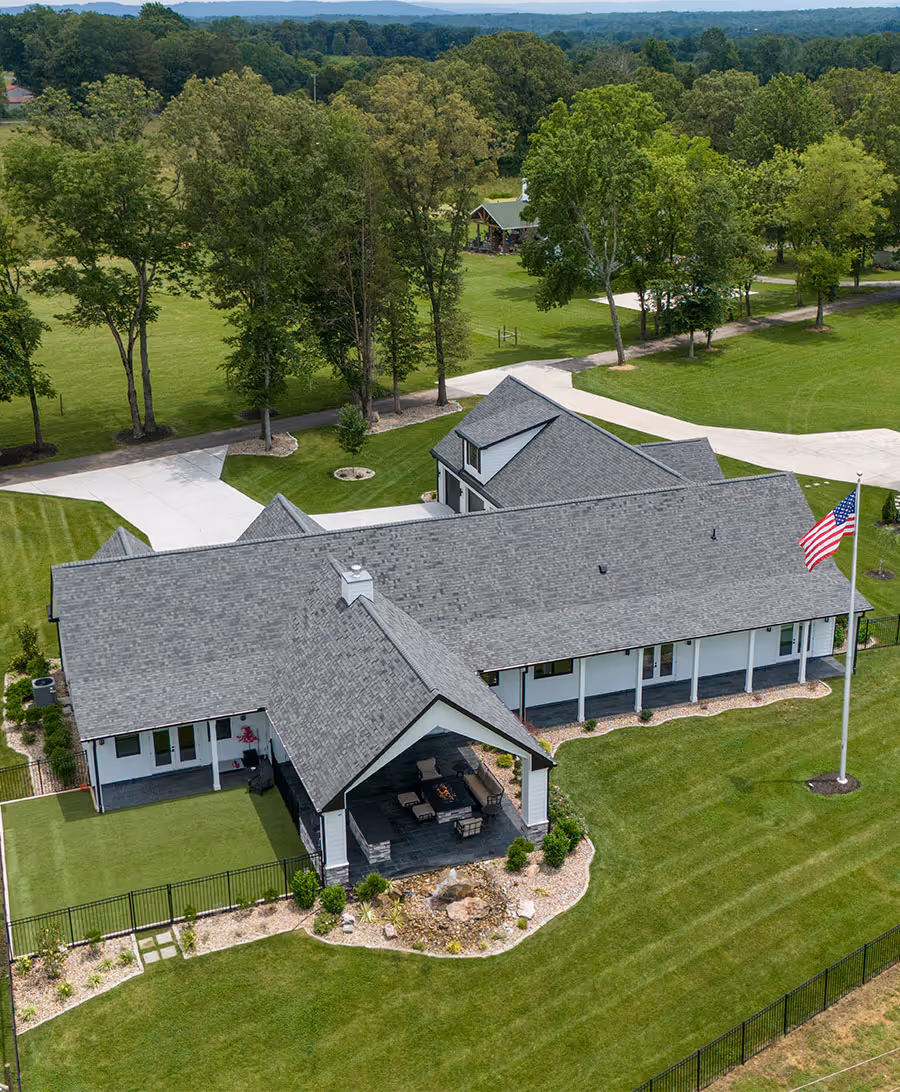 Luxury custom home with an outdoor patio and scenic landscaping, showcasing the RS Signature Homes building process.