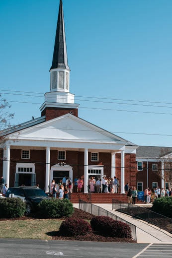 a group of people outside a church