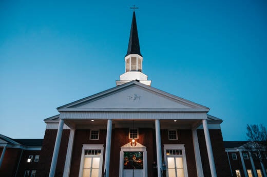a building with a steeple and a blue sky