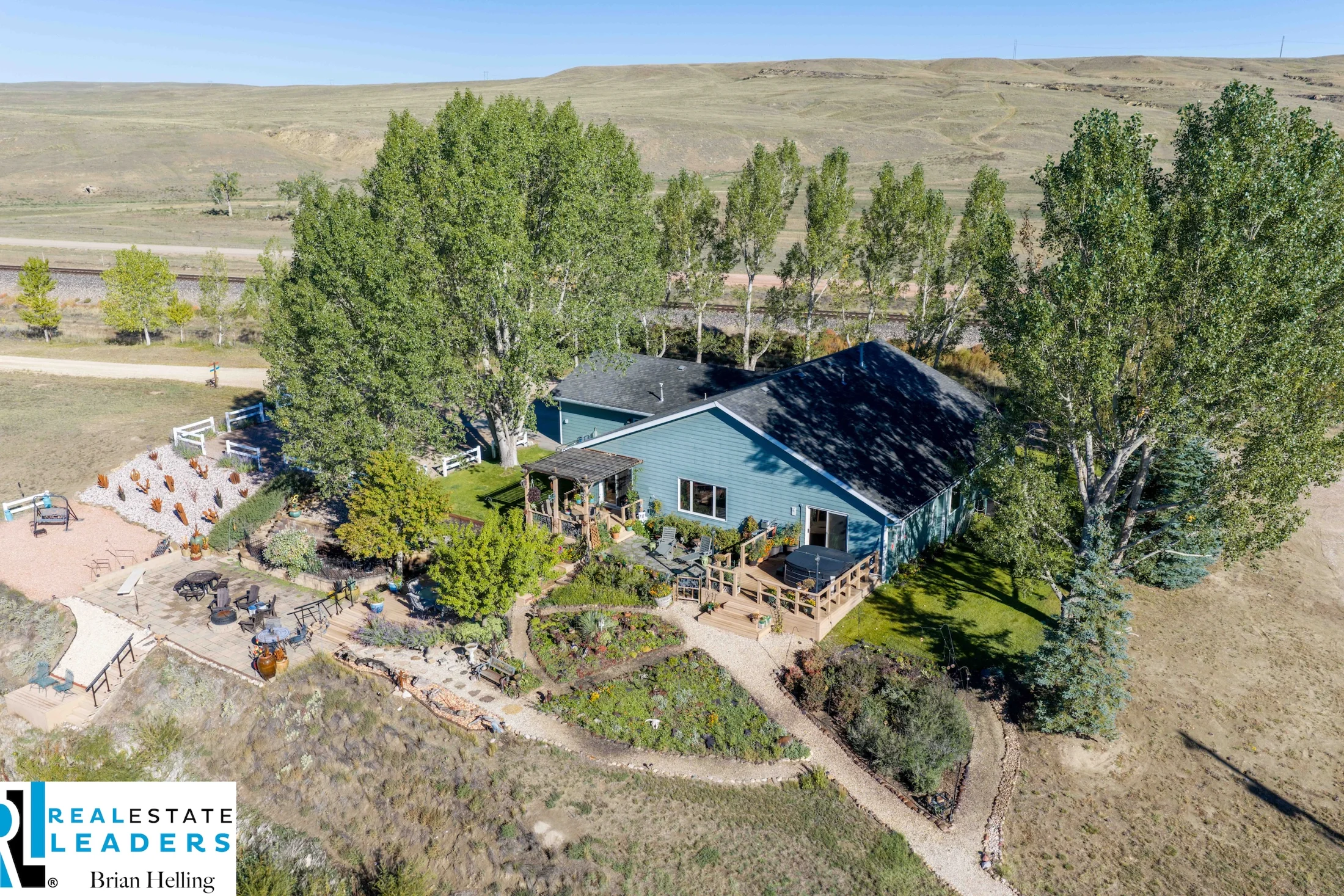 Aerial view of the home, riverside deck and mature trees