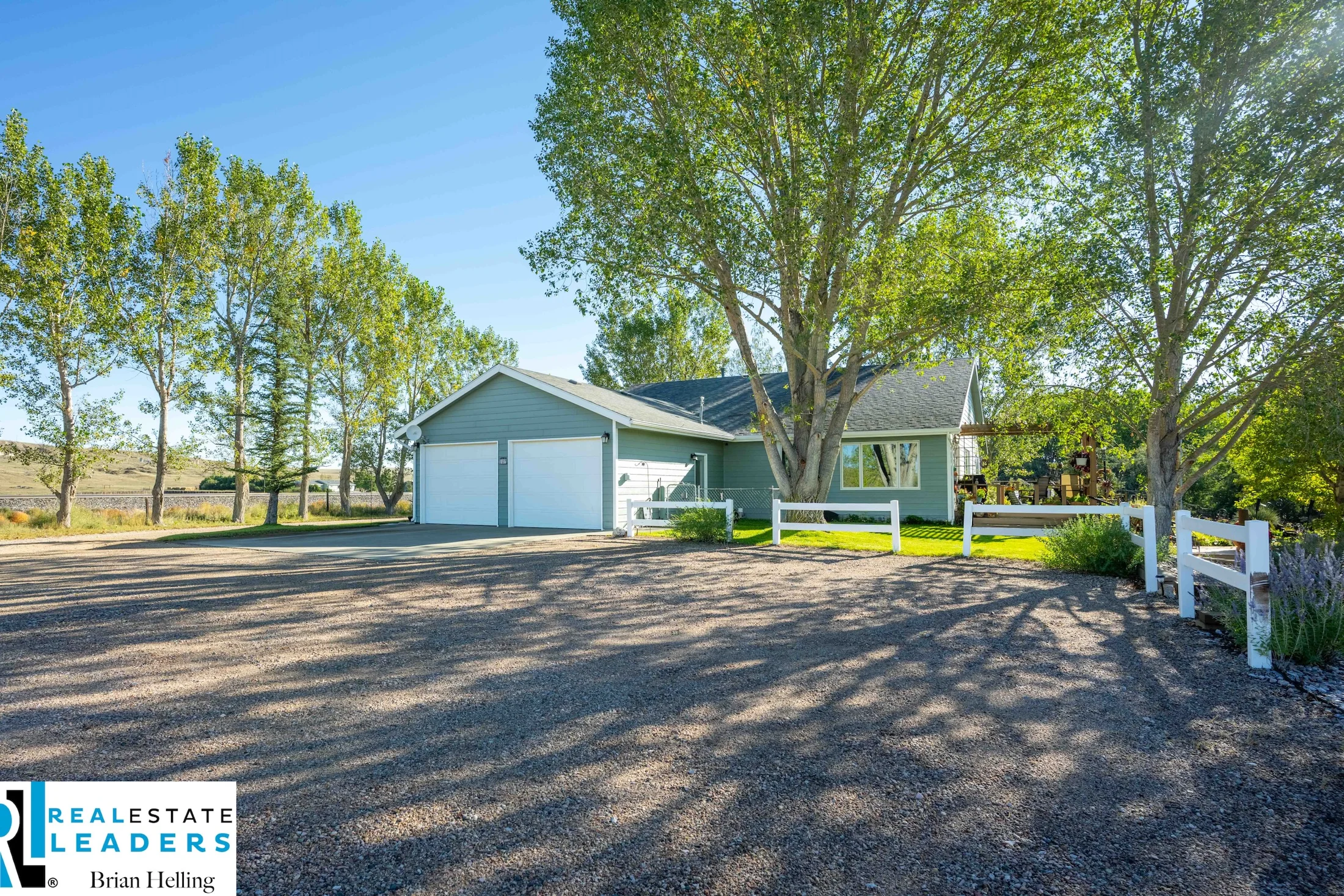 The tree-lined approach and attached garage