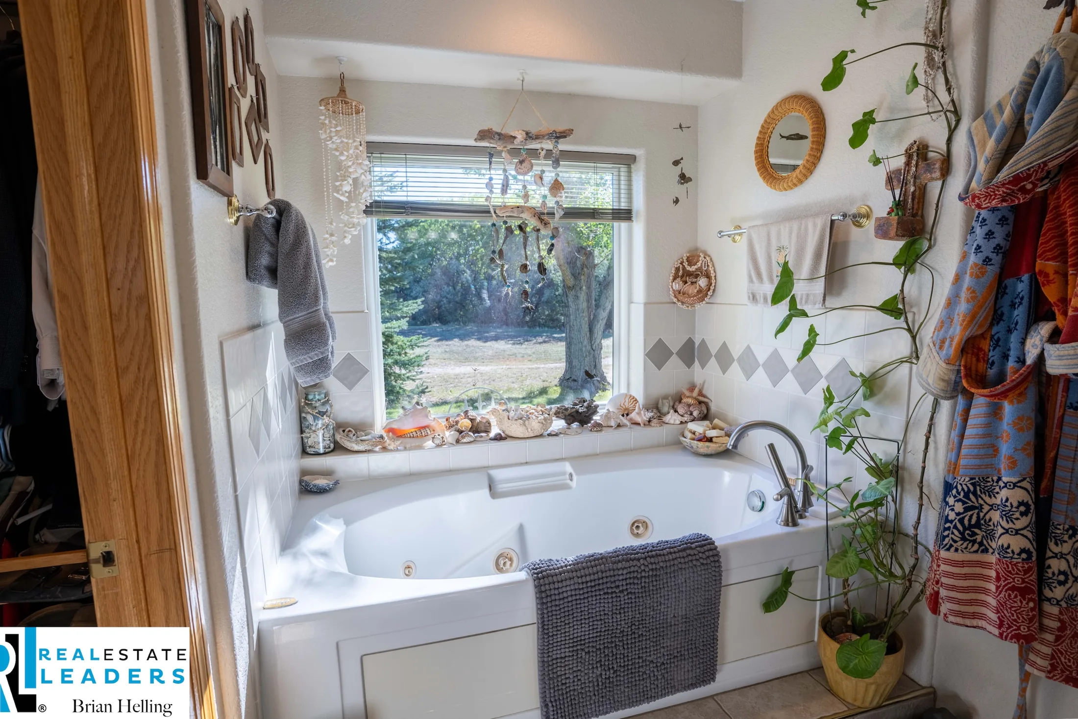 A soaking tub beneath a garden-facing window