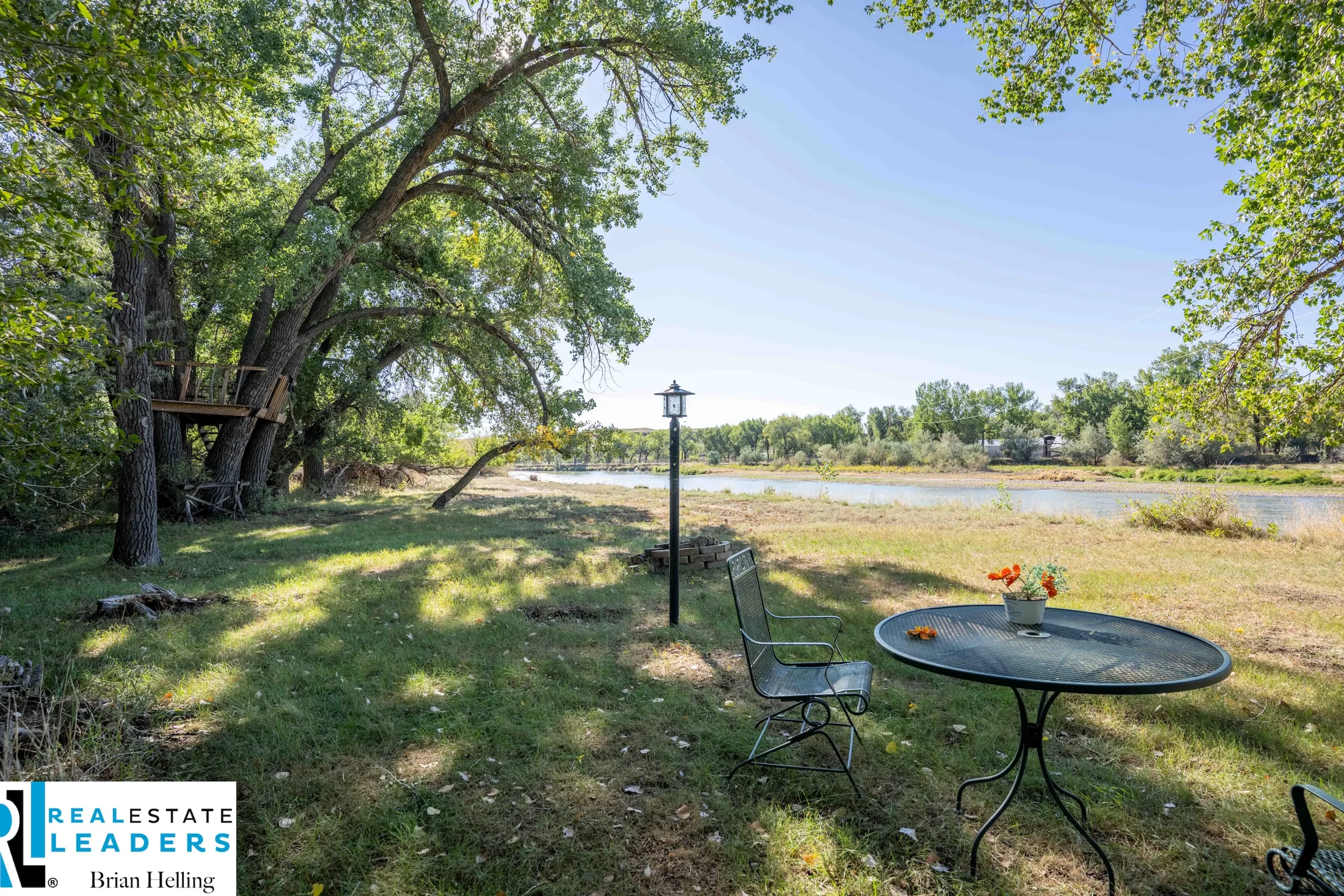 A shaded table beside the river