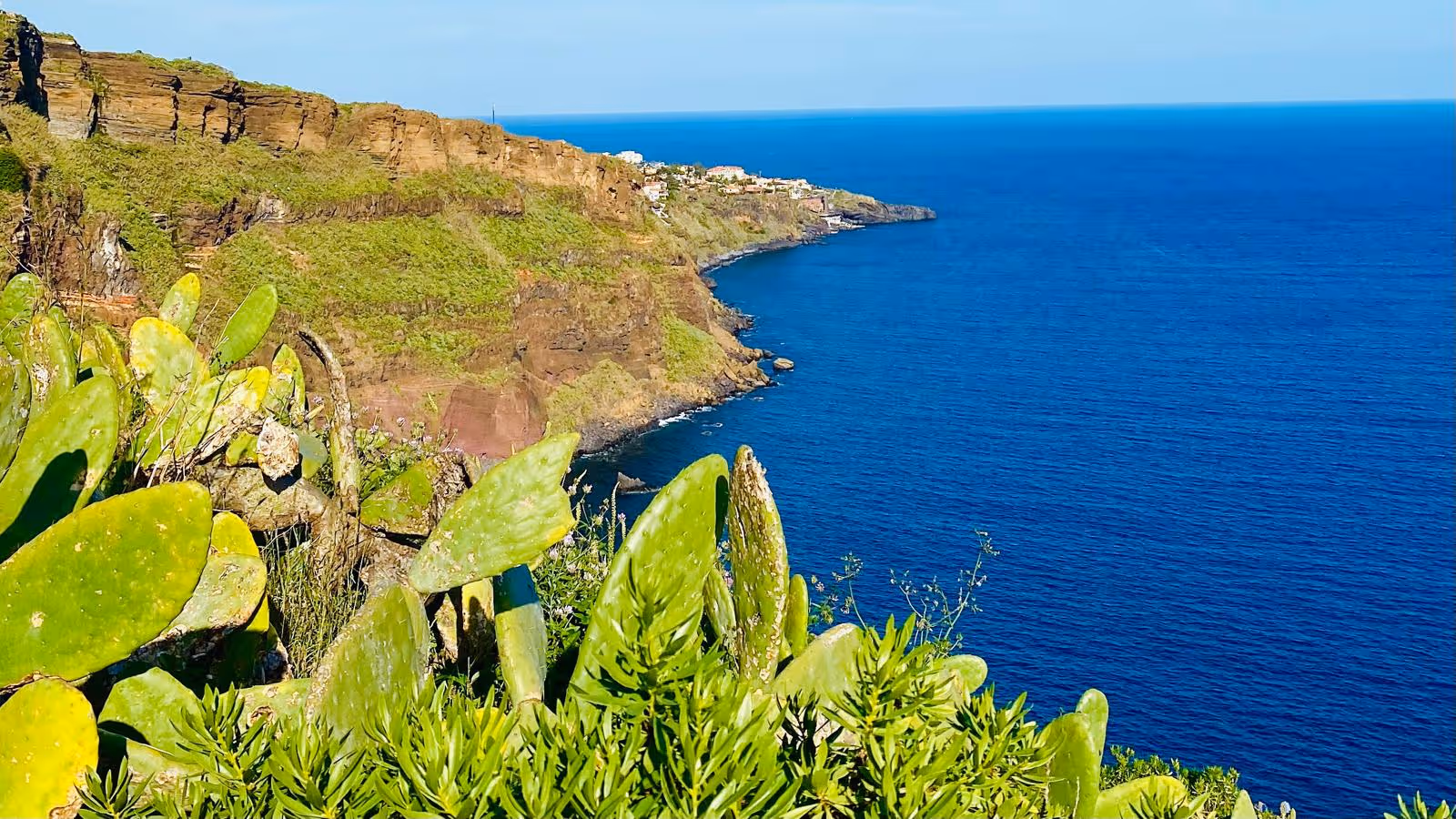 Where the blue atlantic meets the lush and green madeira at the viewpoint of Jesus Crist in Madeira