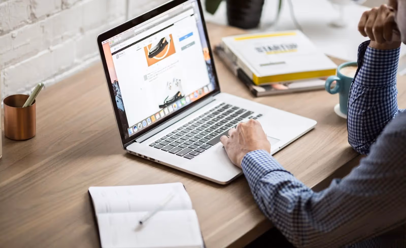 A man scrolling on a laptop