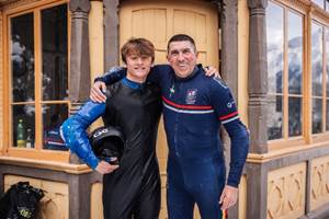 Two men in wet suits posing for a picture

AI-generated content may be incorrect.
