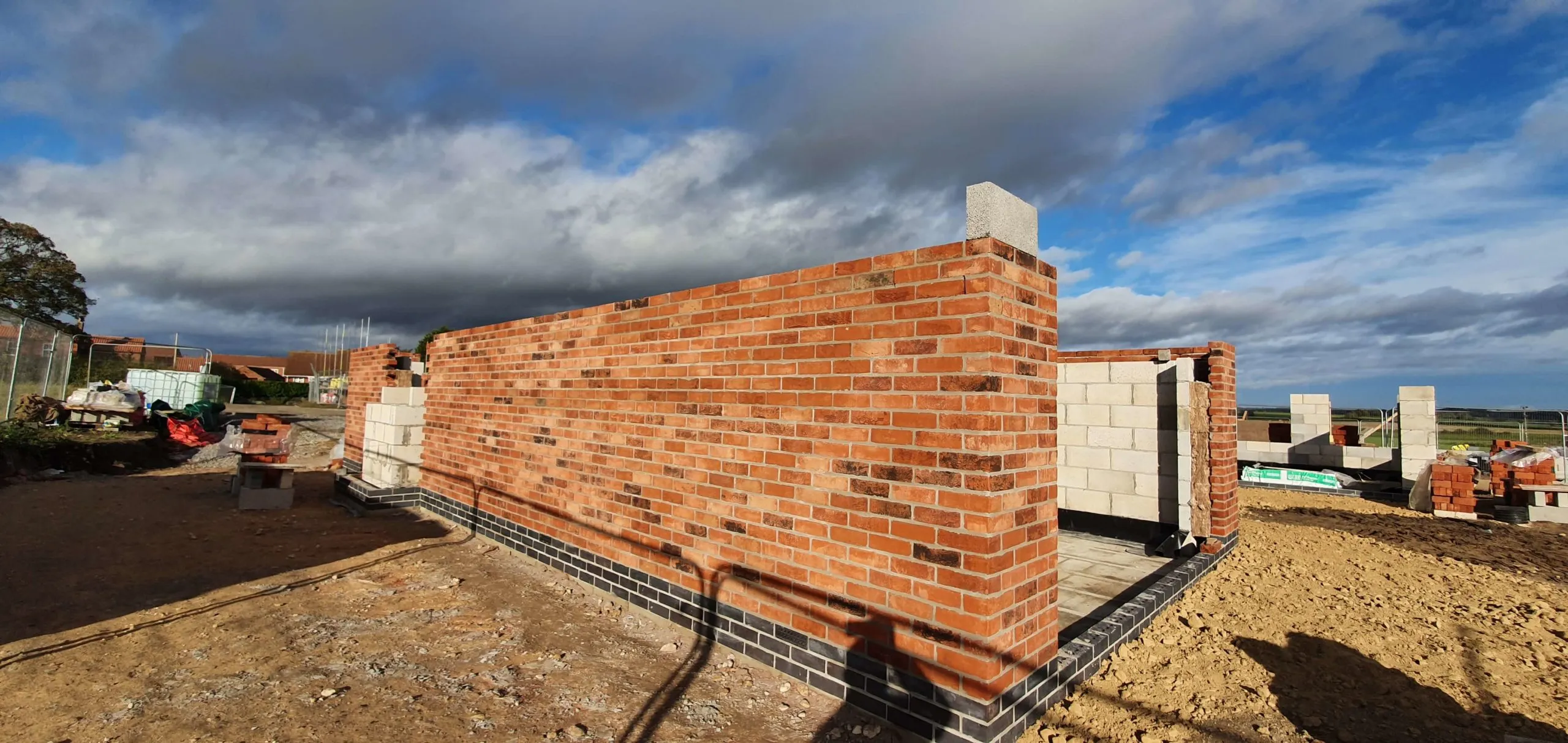 A brick wall with a shadow of a person on it.
